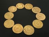 a close up of a circle of gold coins on a black surface