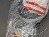 a bag of socks and a pair of gloves on the ground
