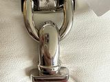 a silver watch on a red strap with a tag attached to it