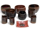many bowls and cups that are sitting on a white surface