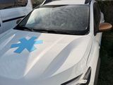 a white car with a blue star on the hood
