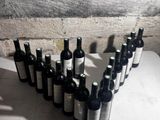 many bottles of wine lined up on a table