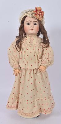 a close up of a doll wearing a dress and hat