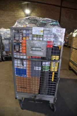 a metal cart with many boxes on it in a warehouse