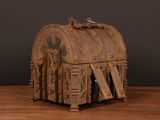 a wooden box with carvings on it sitting on a table