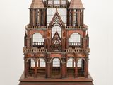 a wooden model of a castle on a small table