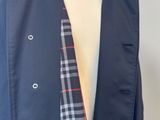 a mannequin torso with a blue jacket and a plaid tie on it