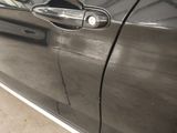 a close up of a car door handle with a sticker on it
