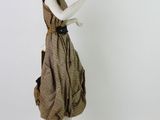a statue of a woman in a dress holding a cell phone