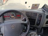 steering wheel of a truck with a tablet on the dashboard