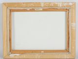 an old picture frame with a piece of wood sticking out of it