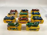 six toy cars are lined up in a row on a white surface