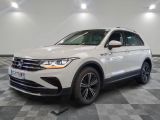 the white volkswagen suv is parked on a checkered tile floor