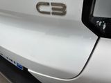 a close up of the emblem on a white car