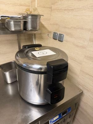 stainless steel counter top with pots and pans on top of it