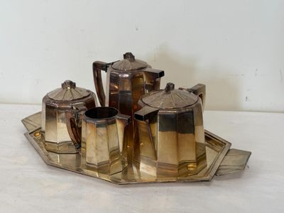 a silver tray with a silver tea set on it