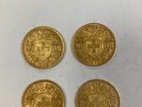 quatre pièces d'or, dont l'une porte un blason et l'autre un bouclier