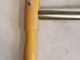 a wooden handle that is attached to a metal object