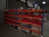 many red bins on the shelves in the warehouse