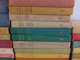 several books stacked on top of each other on a white surface