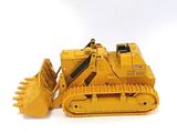 a yellow toy bulldozer sitting on a white surface