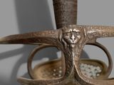 a close up of a sword with a handle on it