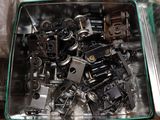 a metal container filled with assorted metal objects on a table