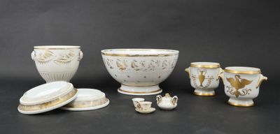 a group of white and gold items on a black surface