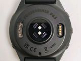the watch is black and has a black dial on the face of it