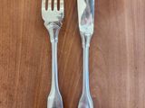 two spoons and a fork on a wooden table