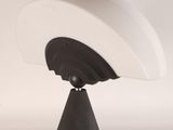a close up of a lamp on a stand on a table