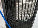 an air conditioner with a blue hose attached to it ' s side
