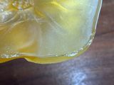 a glass of lemonade with a slice of lemon in it