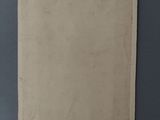 an old photo of a piece of paper on a table