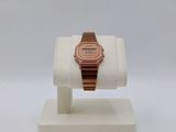 a watch that is on a display stand on a white surface