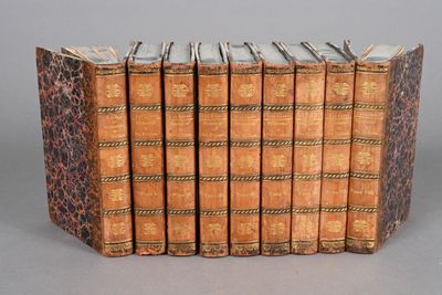 a group of six books sitting on top of each other on a table