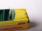 a yellow toy car that is sitting on top of a box