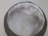a bowl of water sitting on top of a white plate