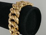 a close up of a gold bracelet on a black ring