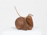 an image of a sculpture of a pear sitting on top of a white box