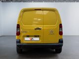 the back end of a yellow van parked in a garage