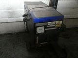 an image of a blue and black machine in a garage