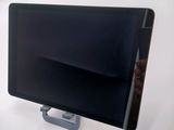 a tablet computer sitting on a stand on a white surface