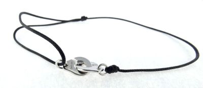 a close up of a black cord bracelet with a silver clasp