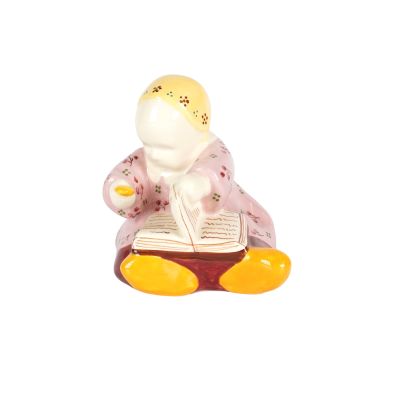 une petite figurine représentant une femme en train de lire un livre