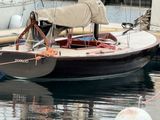a small boat that is tied up to the dock