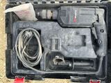 a tool in a case that is sitting on the ground