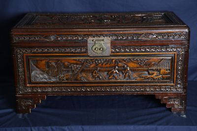 a wooden box with carvings on it on a blue background