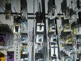 many different types of cell phones hanging on the wall