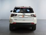 the rear end of a white suv parked in a room